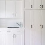 Amazing All white laundry room features white shaker cabinets adorned with oil  rubbed white cabinets for laundry room