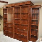 Cozy Bookcases hide a Murphy Bed. Bookcases swing open to reveal bed. Side bookcase wall bed