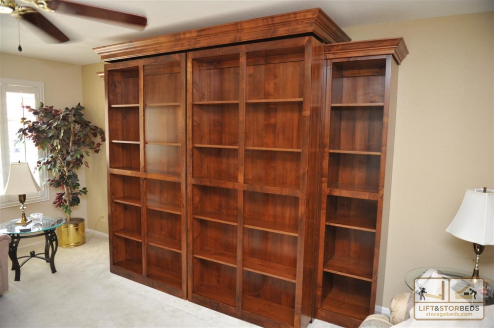 Cozy Bookcases hide a Murphy Bed. Bookcases swing open to reveal bed. Side bookcase wall bed