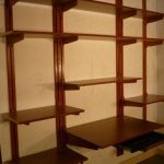 Elegant Adjustable, wall-mounted shelving that is all wood wall mounted adjustable shelving