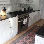 Elegant Rug in the kitchen. Nice marble backsplash with black counters (which is kitchen runner rugs