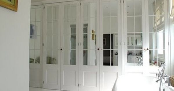 Master Droooooling over these closet doors! Wall-to-Wall mirrored French doors  with white mirrored wardrobe doors