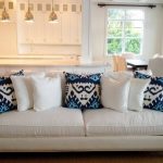 New White sofa with white and blue throw pillows. white sofa pillows