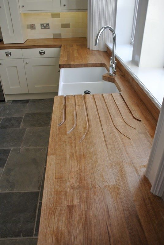 Stylish kitchen with solid oak worktop and customised drainage grooves wooden kitchen work tops