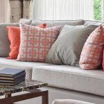 Unique Light grey sofa with a mix of bright orange and matching solid accent pillows for sofa