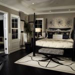 black furniture rich bedroom with dark flooring and furniture. DADWZNB