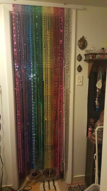 Mardi gras beads into a beaded door curtain.