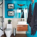 Modern Small Bathroom With Bold Teal Walls, Floating Vanity and Animal Wall  Decor