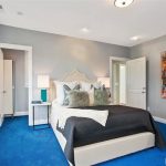 Bedroom with gray whiles and bright blue carpet