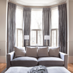 bay windows and grey curtains. Source. swing arm living room curtains