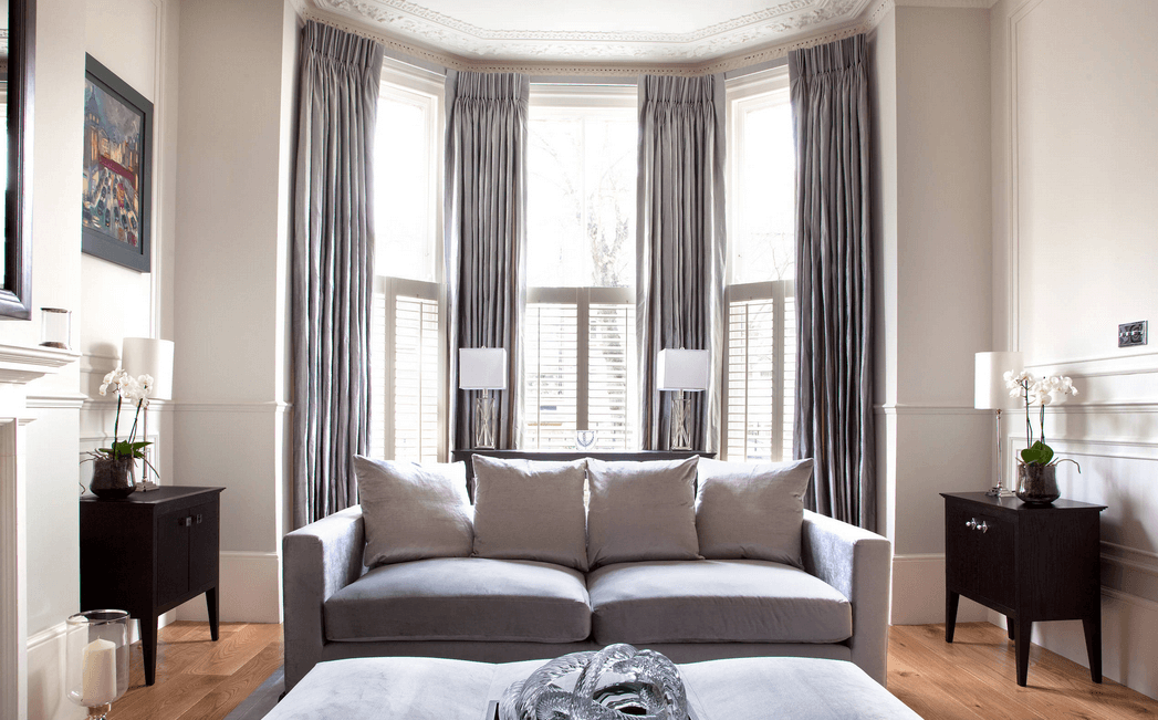 bay windows and grey curtains. Source. swing arm living room curtains