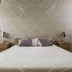 Light bedroom with decorative wallpaper and large double bed Stock Photo -  65140089