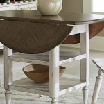 drop leaf table in a dining room with white chairs