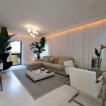 View in gallery Goregous living room in white with orange LED lighting and  a tropical touch