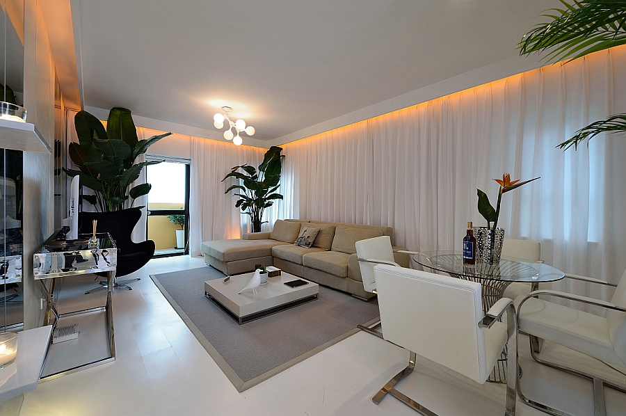 View in gallery Goregous living room in white with orange LED lighting and  a tropical touch