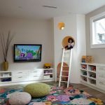 Kids playroom, large floral area rug, knit poufs, custom kids play house  with white ladder | MaK Interiors
