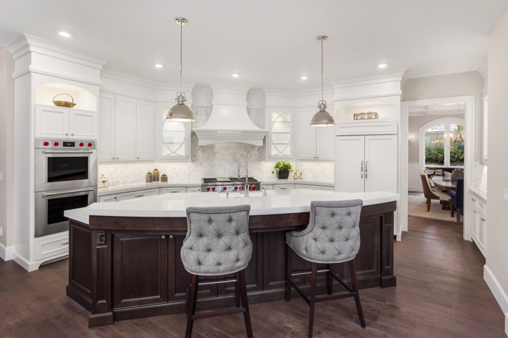 Elegant white kitchen with large curved island