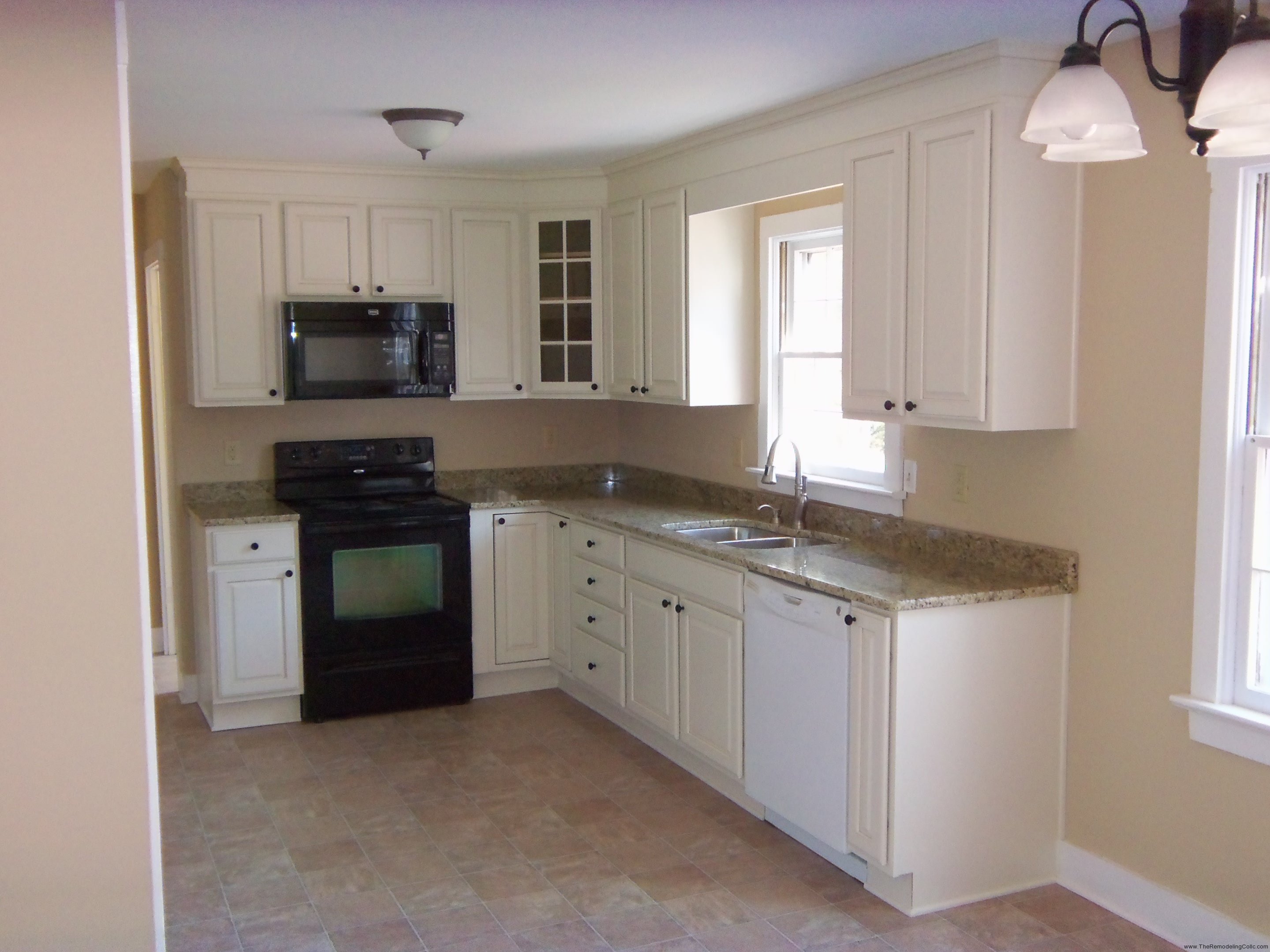 L white wooden kitchen cabinet and mocha granite countertop connected by  black stove and