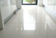 large white kitchen floor tiles. We put shiny white tiles in our bathroom  and they always look great - and are actually easy to keep clean.