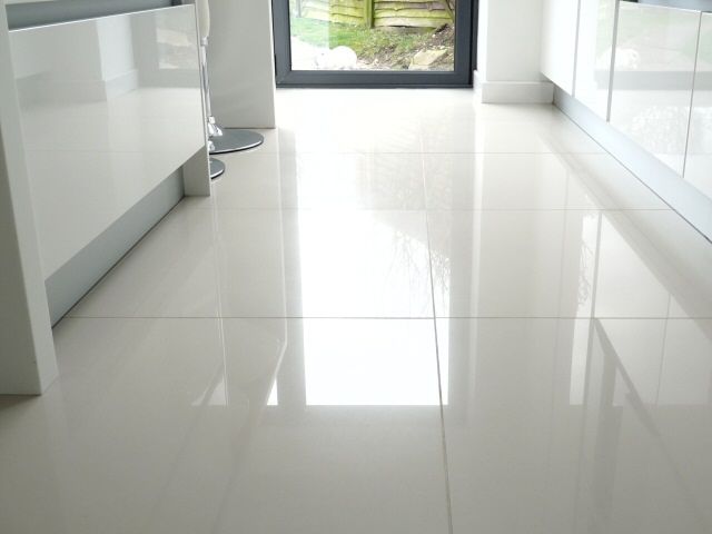 large white kitchen floor tiles. We put shiny white tiles in our bathroom  and they always look great - and are actually easy to keep clean.