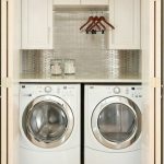 Side by side laundry closet with hanging rod and cabinets | Laundry