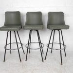 This set of three mid century bar stools by Atlas Specialty Manufacturing  feature a green vinyl