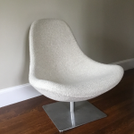 A cozy modern upholstered chair with a stainless steel swivel square base.  This new but. Anglo-Indian Mid Century Modern Swivel Lounge