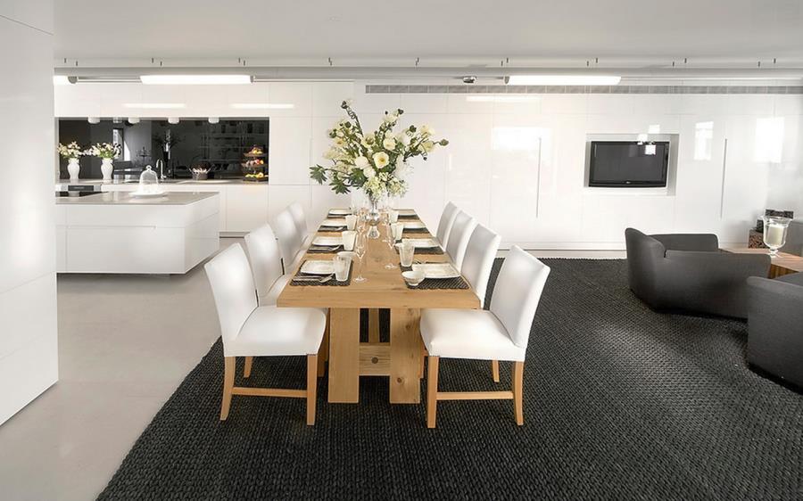 View in gallery Large textured black rug in a dining and living area