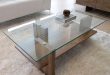 A great example of a modern glass/wood coffee table. The design is  streamlined, allowing the quality of the materials used to shine through.