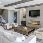 Example of a huge minimalist open concept medium tone wood floor and brown  floor living room