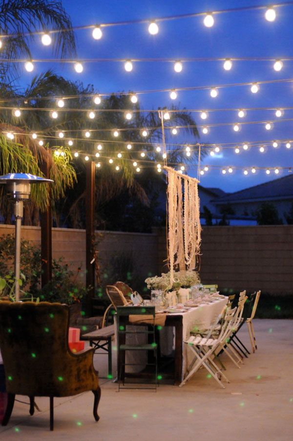 Festoon lights strung across a yard |52 Spectacular outdoor string lights  to illuminate your patio