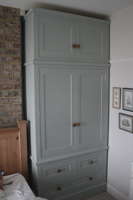 Traditional shaker style painted wardrobes built to fit snuggly in an  alcove of a period style house.