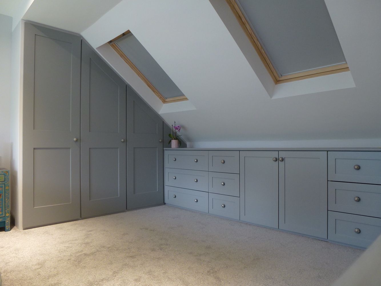 Fitted wardrobes built into loft conversion. Storage drawer units shaker  style doors and drawers. Pull out hanging rails.