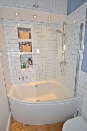 simple corner tub/shower combo in small bathroom | bathroom