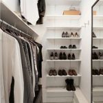 perfect minimalist closet layout with a leading rack on one wall, a mirror  on the