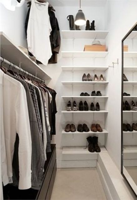 perfect minimalist closet layout with a leading rack on one wall, a mirror  on the